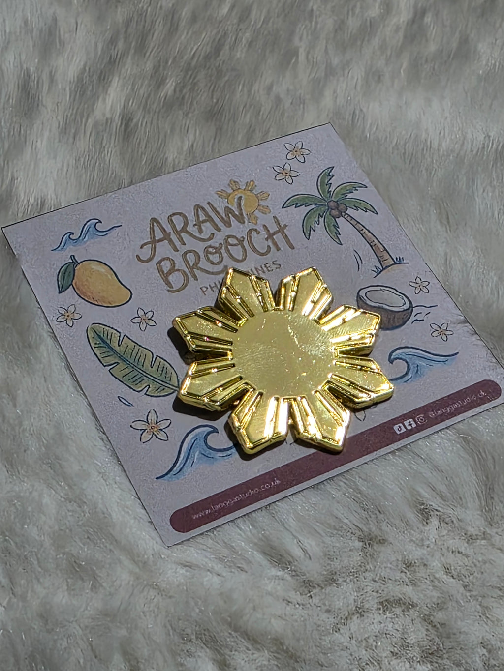 Golden ARAW Brooch