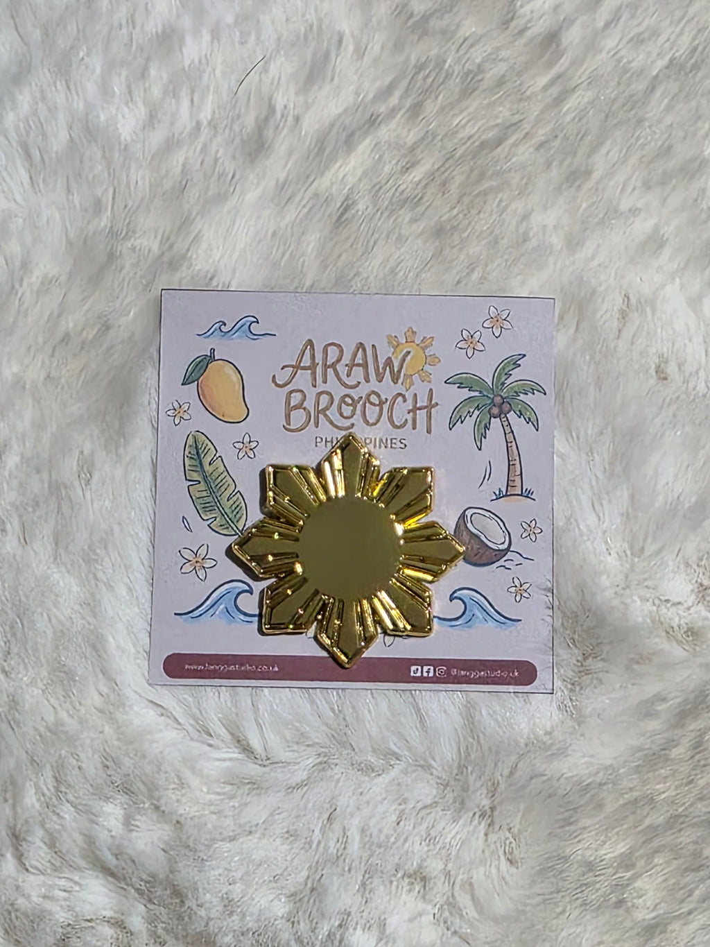 Golden ARAW Brooch